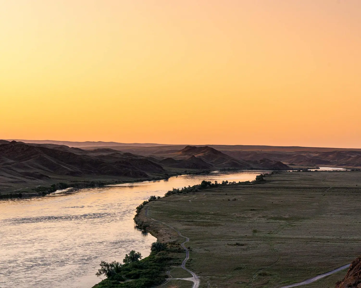 Ili River winding through steppe landscape at sunset